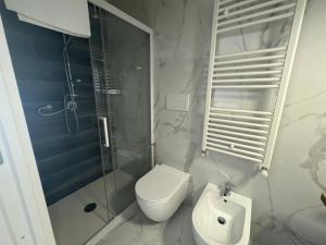 a bathroom with a toilet and a shower and a sink at Casa MarFe in Grottaglie