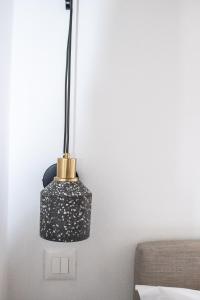 a black lamp on a wall next to a bed at Duchess Harbour View in Symi +51 photos