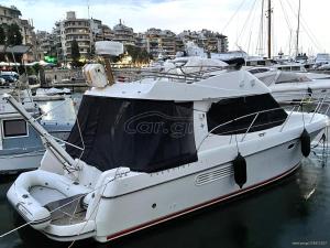 a white boat is docked in a harbor at Solmar Yacht in Aegina Town