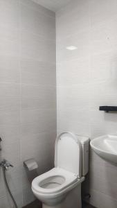 a bathroom with a toilet and a sink at SAFIYA Homestay Vista Alam in Shah Alam