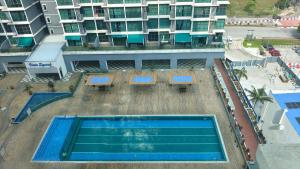 an overhead view of a swimming pool in front of a building at SAFIYA Homestay Vista Alam in Shah Alam