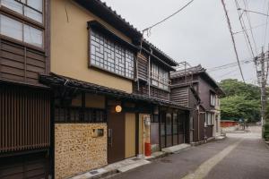a building with wooden doors and windows on a street at ZOPA Nishicho in Kanazawa