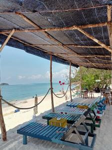 a group of blue chairs on a beach at Redang Campstay A Frame in Redang Island