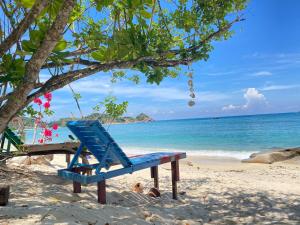 a blue chair sitting on a beach near the ocean at Redang Campstay A Frame in Redang Island