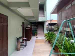 a hallway of a house with a staircase and plants at Baiput Ayutthaya, Self check-in in Phra Nakhon Si Ayutthaya