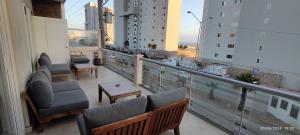 a balcony with chairs and a table on a building at Rosarito Beach condominio in Rosarito +11 photos