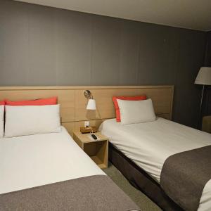 Postel nebo postele na pokoji v ubytování Hotel Shalom Jeju