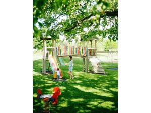 a boy and a child playing on a playground at 3 Gerlitzen - at Lake Faak Karglhof in Faak am See