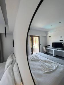 a mirror reflecting a bed in a bedroom at Blue Green Bay in Panormos Skopelos