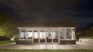 een huis met glazen deuren en ramen 's nachts bij Villa Intelvi in Castiglione dʼIntelvi