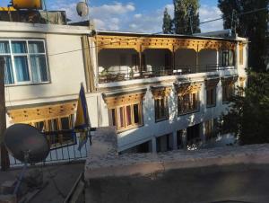 a large white building with a lot of windows at Hotel O Gongma Guest House in Leh