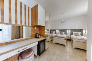 a hotel room with two beds and a bathroom at Hotel &Scaron;ARS in Dobra Voda