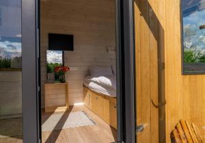 a sauna with a bed and a window at Ezy House 2 by Tiny Away in Ézy-sur-Eure