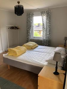 a bedroom with a large bed and a window at Villan med egna sovrum för de flesta in Västervik
