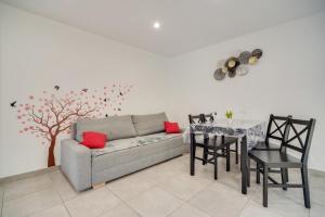 a living room with a couch and a table and a tree at La Sérénade Numéro 1 in Montreuil