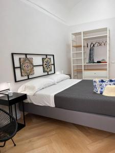a bedroom with a large bed and a desk at La Corte di Atrani in Atrani