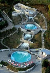 an aerial view of three pools in a resort at Apartmani Star in Tuzla