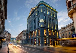a tall blue building on a city street at Astoria Hotel in Lviv