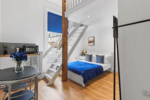 a bedroom with a bed and a staircase at Zee homes W6 in London