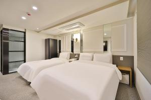 Rubato Hotel Ulsan Junggu客房内的一张或多张床位