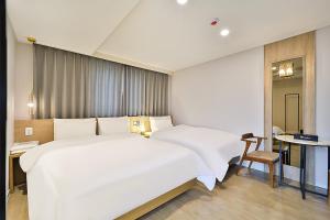 Rubato Hotel Ulsan Junggu客房内的一张或多张床位