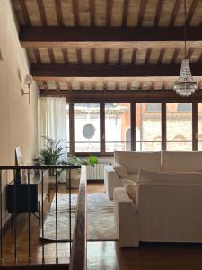 a living room with a couch and a table at Calmaggiore Apartment - Luxury group apartment in Treviso