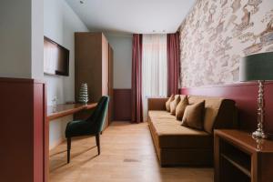 a living room with a couch and a chair at Hotel Miramare in Civitanova Marche