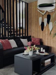 a living room with a couch and a coffee table at Brīvdienu māja & pirts meža vidū - Saraiķu Sanderi in Saraiķi +50 photos