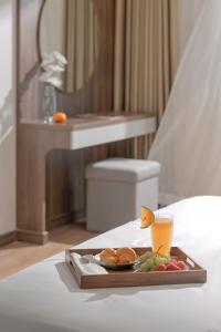 a tray of food on a table in a hotel room at PANAMA Nha Trang Hotel in Nha Trang