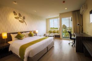 Llit o llits en una habitació de Tamarind Garden Hotel