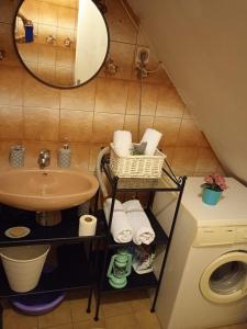a bathroom with a sink and a washing machine at Apartment Vinko in Šibenik