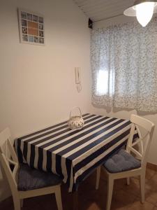a table with a blue and white striped table cloth at Apartment Vinko in Šibenik +33 photos