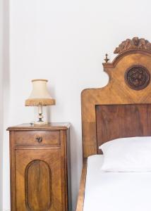 a lamp on a night stand next to a bed at Giunio house, Old town centre in Korčula