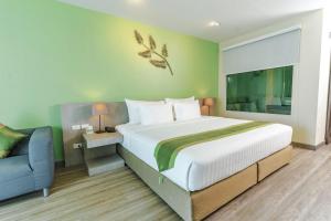 Llit o llits en una habitació de Tamarind Garden Hotel