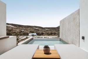 a view of a pool from the balcony of a house at Domes White Coast Milos, Adults Only - Small Luxury Hotels of the World in Mytakas
