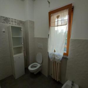 a small bathroom with a toilet and a window at uriel 4 in Giovinazzo +15 photos