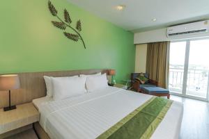 Llit o llits en una habitació de Tamarind Garden Hotel