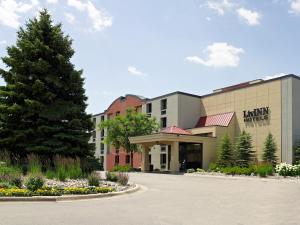 a hotel with a tree in front of a building at LivINN Hotel Minneapolis South / Burnsville in Burnsville