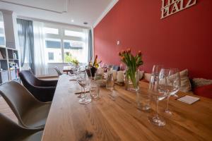 a long wooden table with wine glasses on it at Der Wolfshof - Dein Zuhause im Harz in Langelsheim