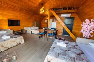 a large room with two beds and a table with chairs at Galaxy Bungalow in Trabzon +10 photos