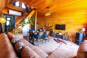a living room with a couch and a table at Galaxy Bungalow in Trabzon