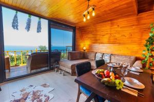 a living room with a table with a bowl of fruit at Galaxy Bungalow in Trabzon