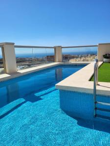 a swimming pool with a view of the ocean at Casa Las Colinas in Roquetas de Mar