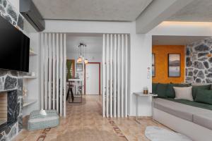 a living room with a couch and a fireplace at Lous House in Agia Paraskevi