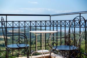 two chairs and a table on a balcony at Lous House in Agia Paraskevi