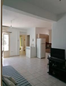 a room with a kitchen and a living room at Ekaterini apartment in Aliki in Aliki +3 photos
