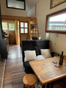 a living room with a couch and a wooden table at Tiny House Triberg in Triberg +13 photos