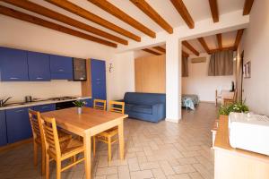 a kitchen and living room with a wooden table and chairs at Agriturismo Mazzeracca in Bassano del Grappa +33 photos