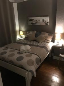 Ένα ή περισσότερα κρεβάτια σε δωμάτιο στο Le Bienvenue Chez Toi