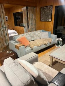 a living room with a couch and a table at Ohingaiti Farm Cottage in Ohingaiti